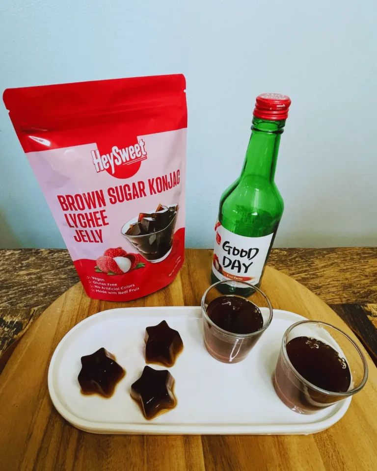 A Valentine’s special lychee jelly dessert featuring HeySweet Brown Sugar Konjac Lychee Jelly, lychee soju, and star-shaped jelly shots served on a white plate.